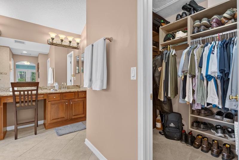 Primary bathroom with dual vanities and seating at 2304 Spring Hill Ct, Orange Park, FL