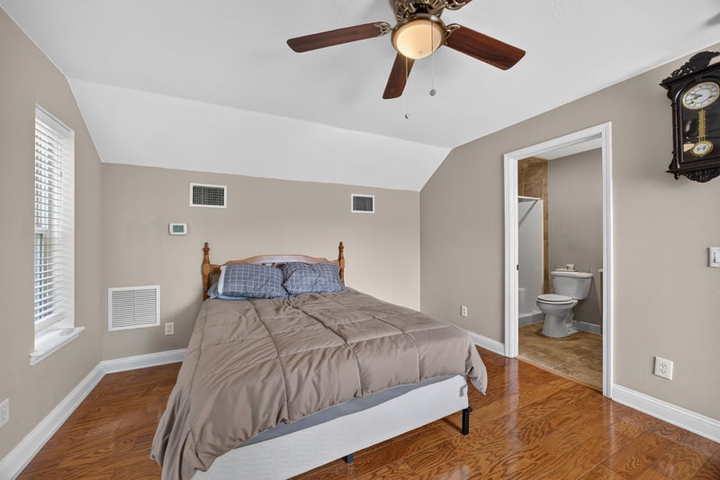 Bedroom with bed and ensuite bathroom door at 1735 Hagans Ridge Ct