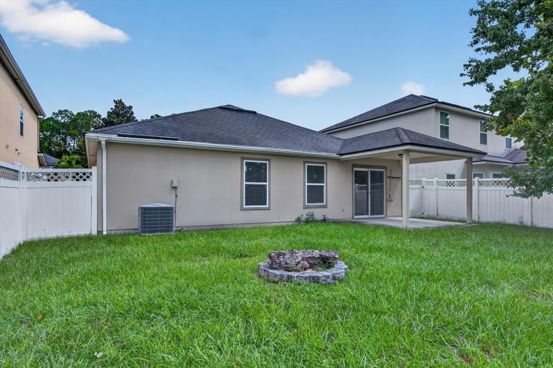 Back exterior with patio and fire pit at 469 Glendale Ln, Orange Park, FL