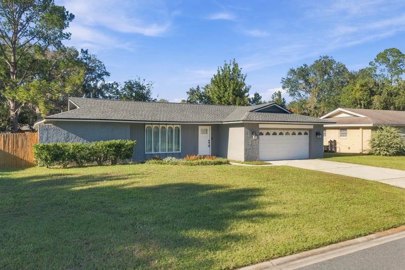 Front exterior view of the home across the lawn, photographed by Megapixeler on Crosby Ln, Orange Park