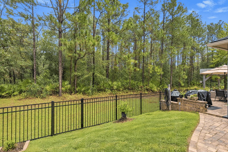 Backyard with wooded view and fence at 10923 Black Diamond Ct, Jacksonville, FL