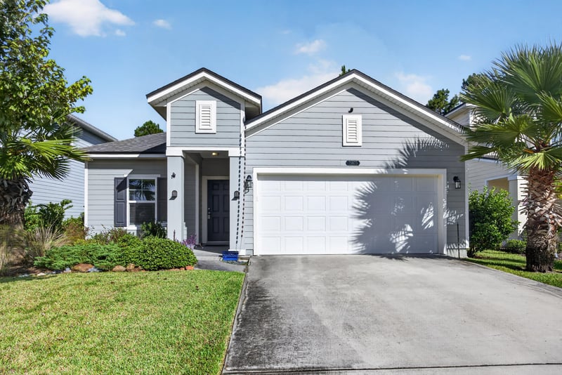 Front exterior view of driveway and gray siding at 75875 Saffron Ln, Yulee, FL 32097