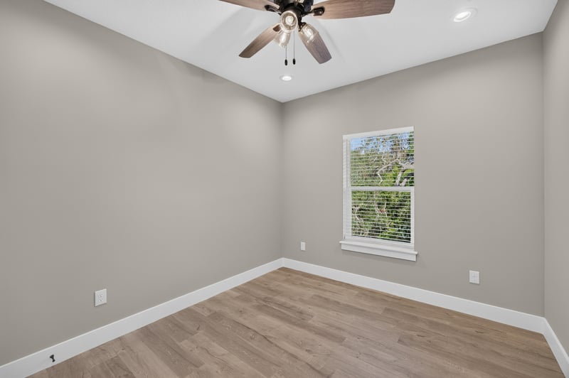 Bedroom with ceiling fan and window at 175 Alava Ct