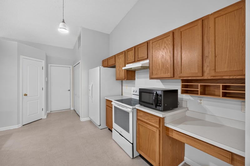 Kitchen with oak cabinets and microwave at 9691 Nelson Forks Dr, Jacksonville, FL 32222