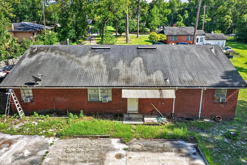 Side exterior with ladder against roof at 5745 110th St, Jacksonville, FL 32244