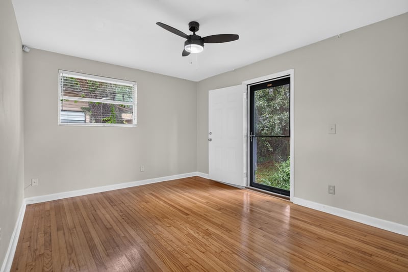 Bedroom with wood floors and sliding glass door at 217 Baisden Rd, Jacksonville, FL 32218
