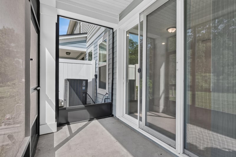 Screened porch with sliding door and yard view at 39 Mellowood Ln, St. Augustine, FL 32092