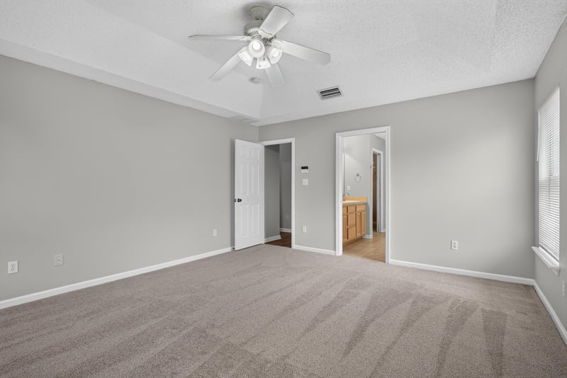 Empty room with carpet and hallway view at 12949 Chets Creek Dr S, Jacksonville, FL 32224
