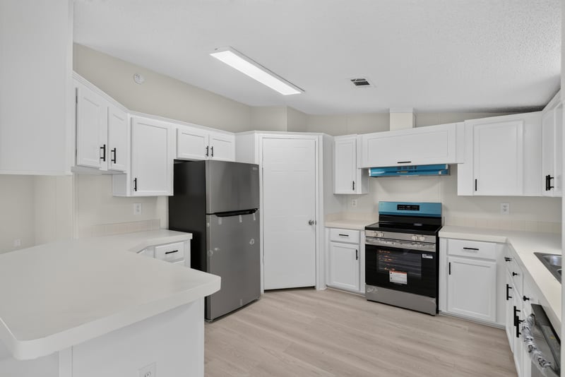 Kitchen cabinets and stainless refrigerator at 7603 Coach Park Dr, Jacksonville, FL 32244