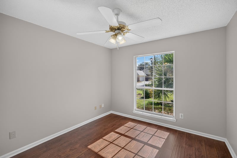 Bedroom with window and wood floor at 11828 Heather Grove Ln, Jacksonville, FL