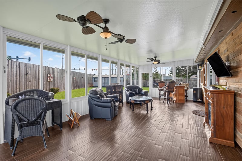 Sunroom with wicker chairs at 6931 Cane Grass Ln E, Jacksonville, FL 32244