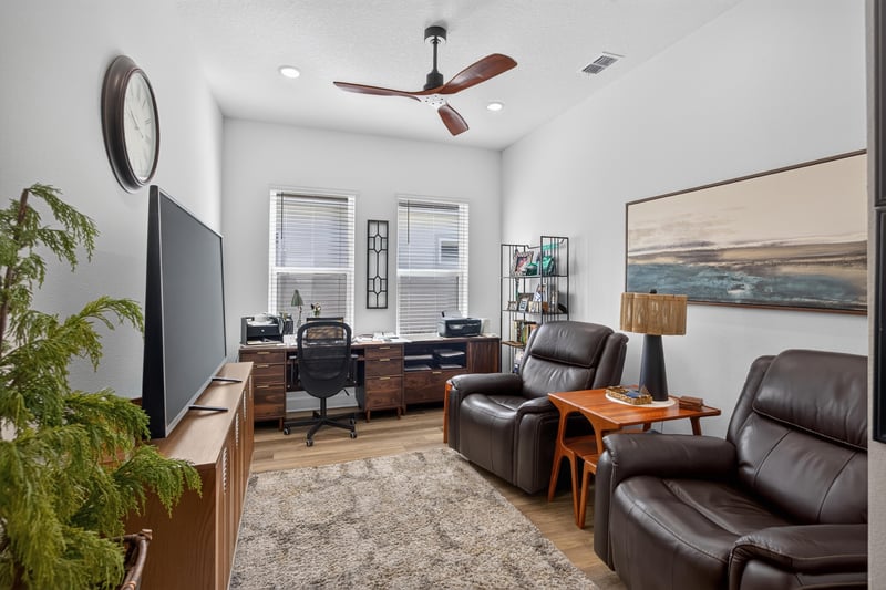 Living area with leather recliners and wall-mounted TV at 129 Amberwood Dr, St. Augustine, FL