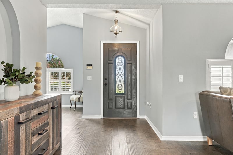 Entry foyer with glass front door and console table at 11197 Illford Dr