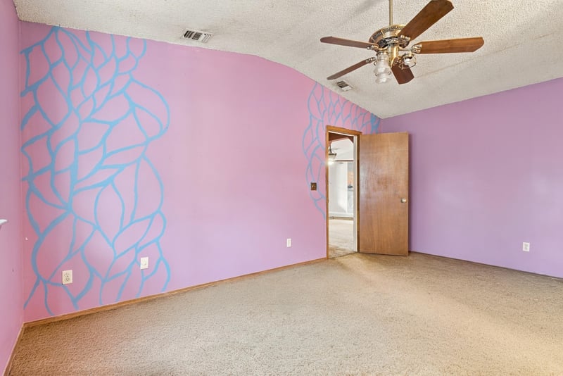 Bedroom with pink accent wall and painted design at 2915 Trenton Ct, Orange Park, FL