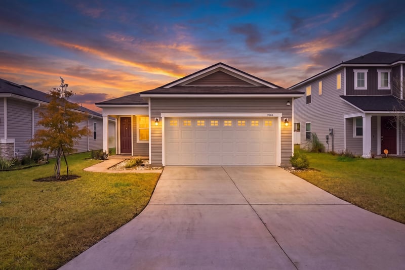 Front exterior at day-to-dusk with colorful sky at 7088 Mahogany Run Dr, Jacksonville, FL 32244