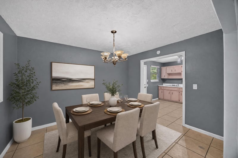 Dining room virtually staged with table and chandelier at 6745 Jack Horner Ln, Jacksonville, FL 32210