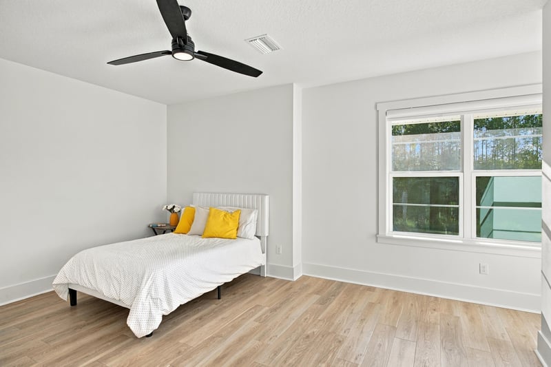 Bedroom with yellow pillows and window at 907 Seagrove Dr, Ponte Vedra Beach, FL 32081