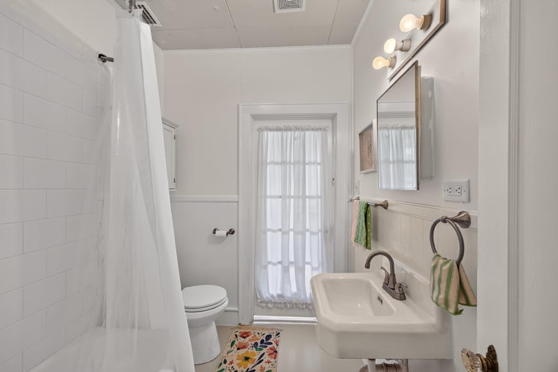 Bathroom with shower and white tile at 101 N Lake St, Crescent City, FL