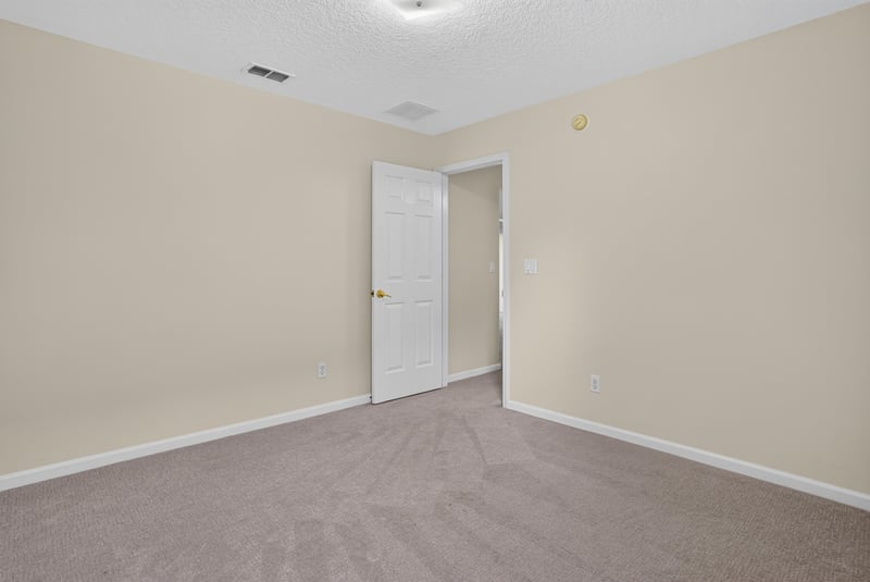 Bedroom with carpet and closet door at 299 John's Creek Pkwy, St. Augustine, FL 32092