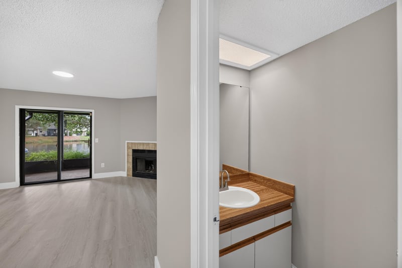 Bathroom vanity with view toward living room fireplace at 3801 Crown Point Rd, Jacksonville, FL 32257