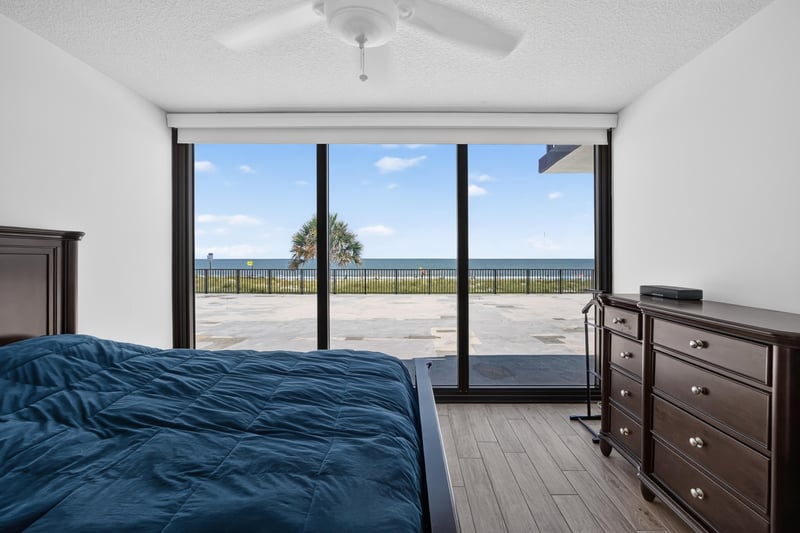 Bedroom with sliding glass doors and dresser at 601 1st St S, Jacksonville Beach