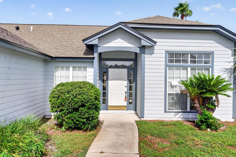 Front entry with stacked-stone accent and window at 400 Ashcroft Landing Dr, Jacksonville, FL 32225