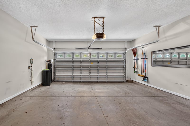 Empty garage bay with overhead storage at 3660 Middlebrook Dr, Orange Park, FL 32065
