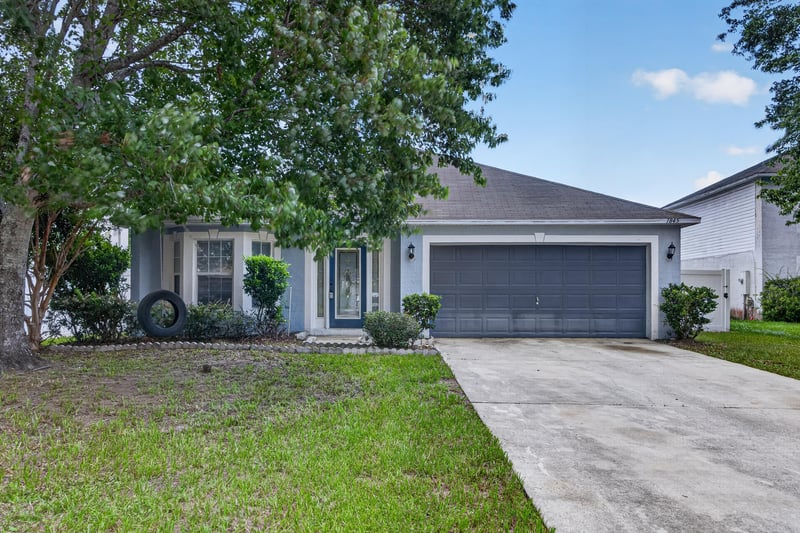 Front exterior view of entry walkway and garage at 1845 Saga Ct, Middleburg, FL