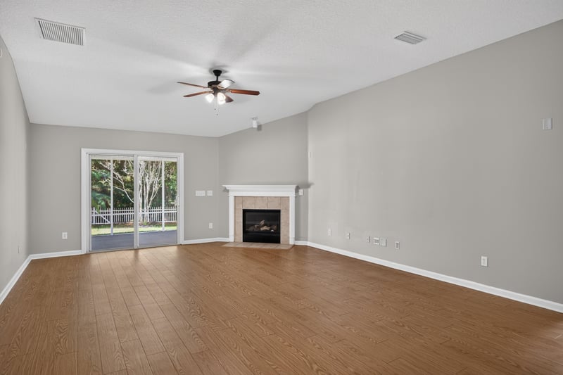Living room with fireplace and ceiling fan at 14147 Fish Eagle Dr E, Jacksonville, FL 32226