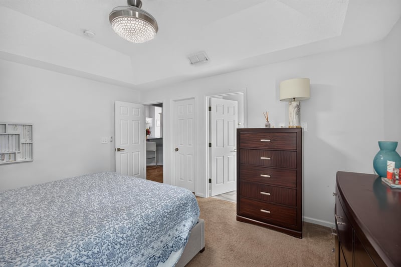 Primary bedroom with dresser and lamp at 12825 Kelsey Island Dr, Jacksonville, FL 32224