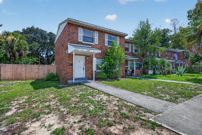 Front exterior view of the brick townhouse with concrete walkway at 2658 Trollie Ln apt 1, Jacksonville, FL 32211