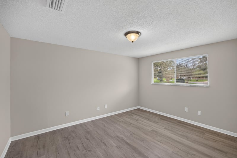 Bedroom with window and wood-look flooring at 1435 Undine Ave, Jacksonville, FL