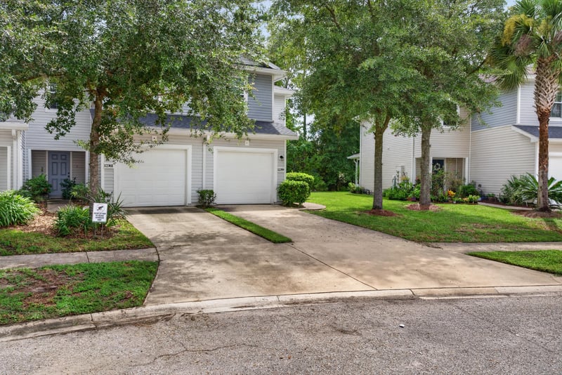 Front exterior view across driveway and lawn at 12359 Mangrove Forest Ct, Jacksonville, FL 32218