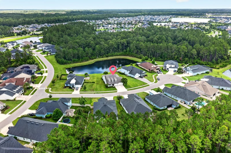 Aerial view with location pin marking the home near a pond in St. Augustine, FL