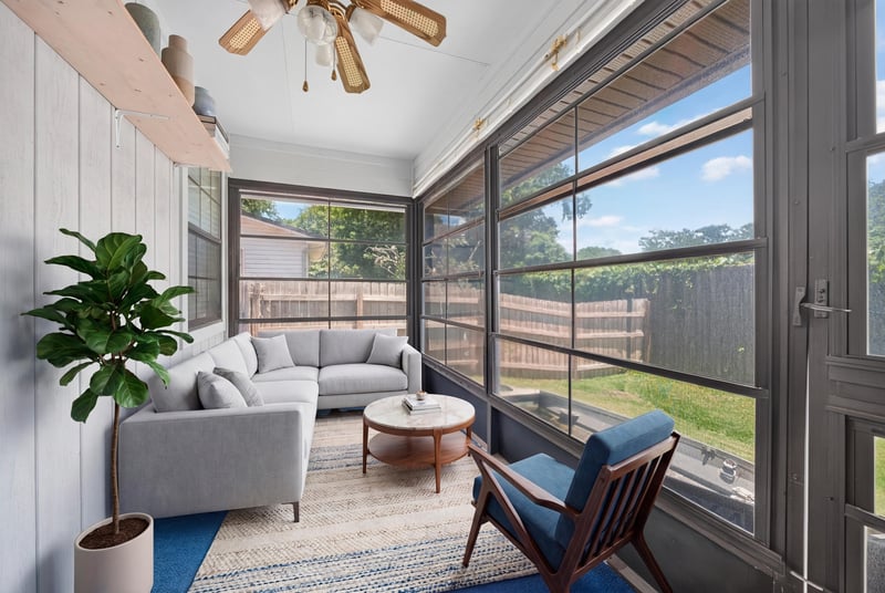 Screened porch furnished with sofa and plant at 2460 San Sago Ln, Jacksonville, FL