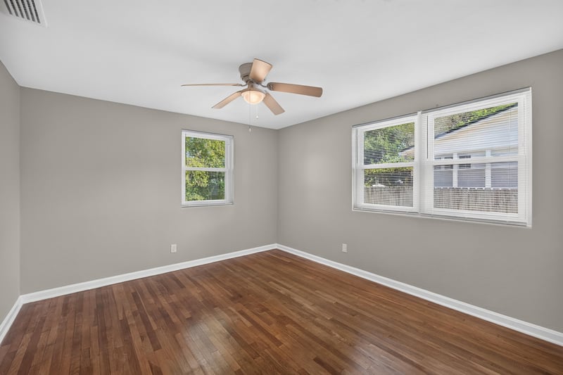 Bedroom with windows and hardwood floors at 6338 Mercer Cir W, Jacksonville, FL