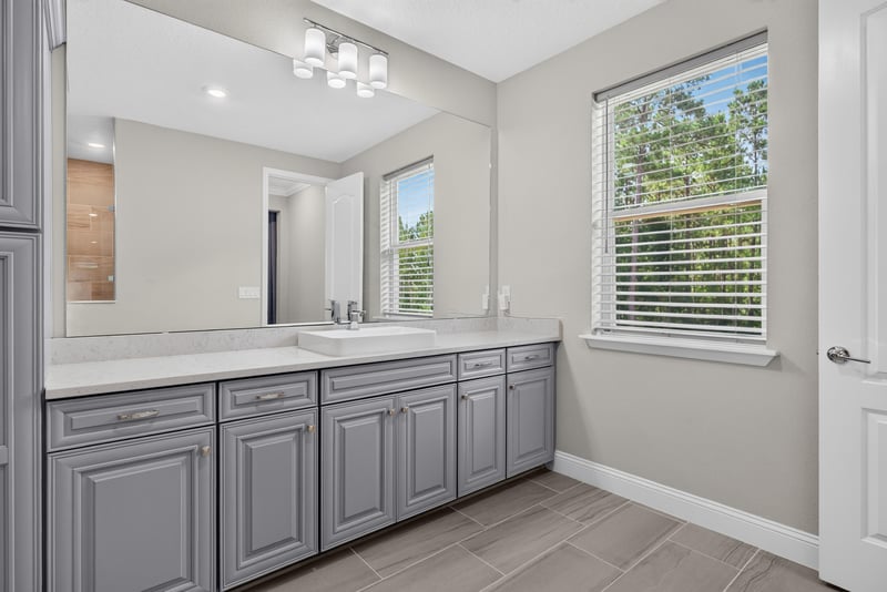 Primary bathroom vanity with window at 22 Azura Point