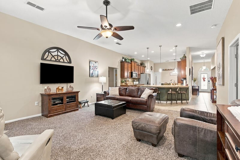 Family room with TV and open view to kitchen at 10923 Black Diamond Ct, Jacksonville, FL