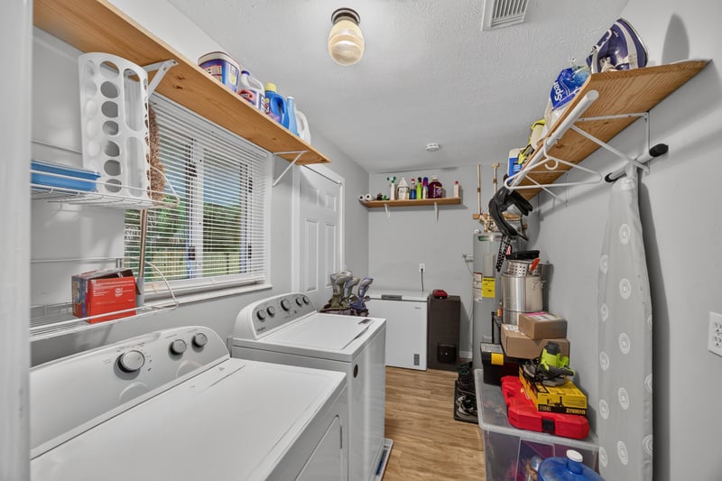 Laundry room with washer, dryer and shelving at 9506 Harriet Ave, Jacksonville, FL 32208