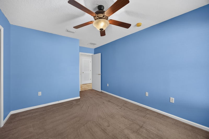Empty bedroom with blue walls and carpet at 2282 Justin Lake Dr, Jacksonville, FL