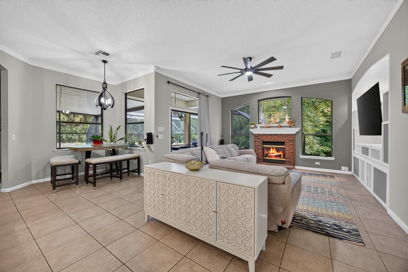 Living room with fireplace and ceiling fan at 2125 Blue Heron Cove Dr, Orange Park, FL 32003