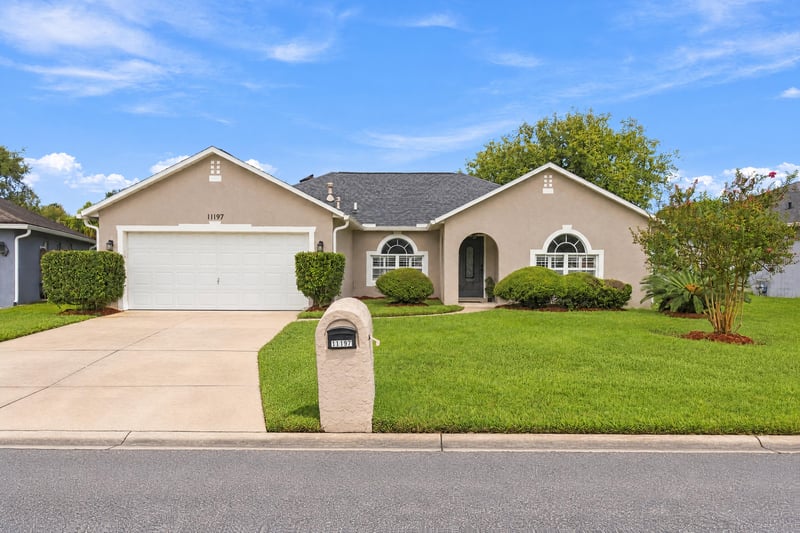 Front exterior with two-car garage and driveway at 11197 Illford Dr