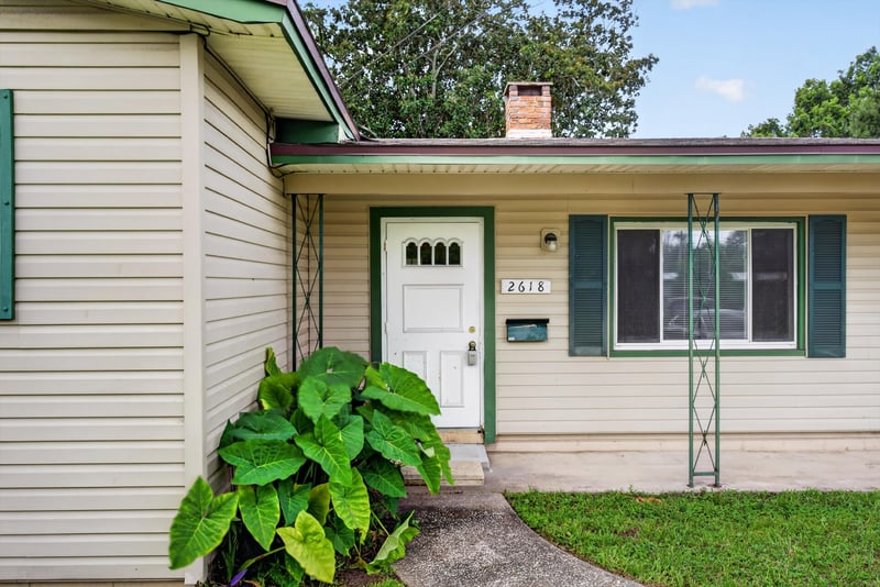 Front door with teal shutters at 2618 Arlex Dr E, Jacksonville, FL