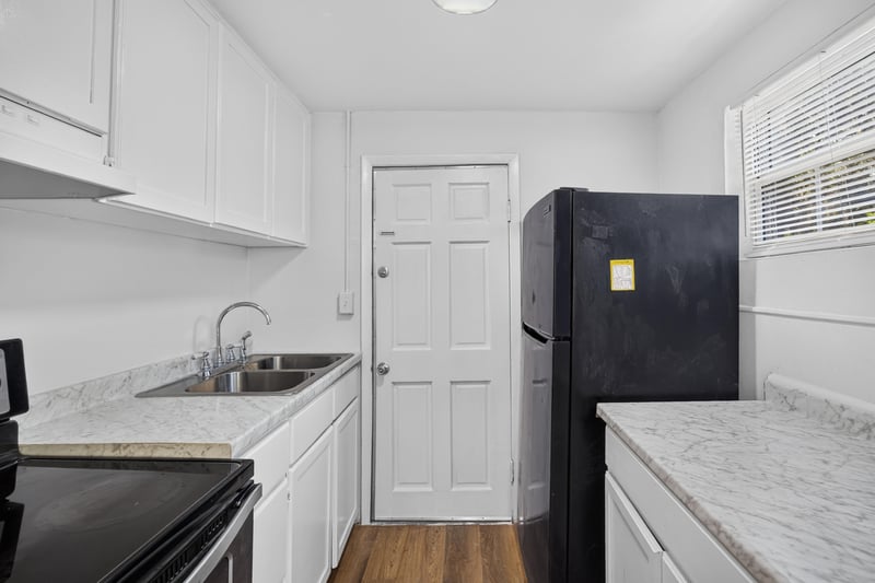 Kitchen sink and black refrigerator at 4951 Halls Dr