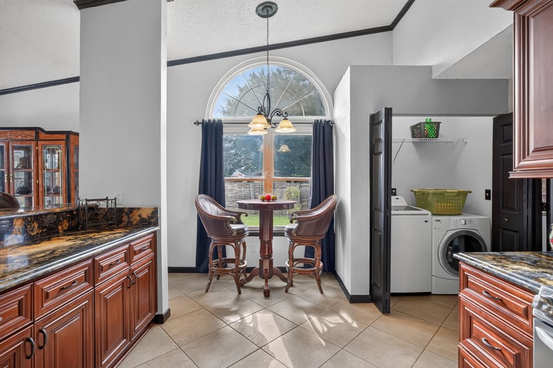 Kitchen laundry nook with arched window at 6931 Cane Grass Ln E, Jacksonville, FL 32244