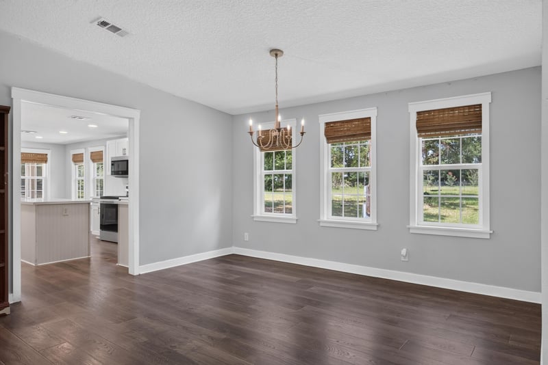 Dining area open to kitchen with chandelier at 4890 McAllister Rd, Middleburg, FL 32068