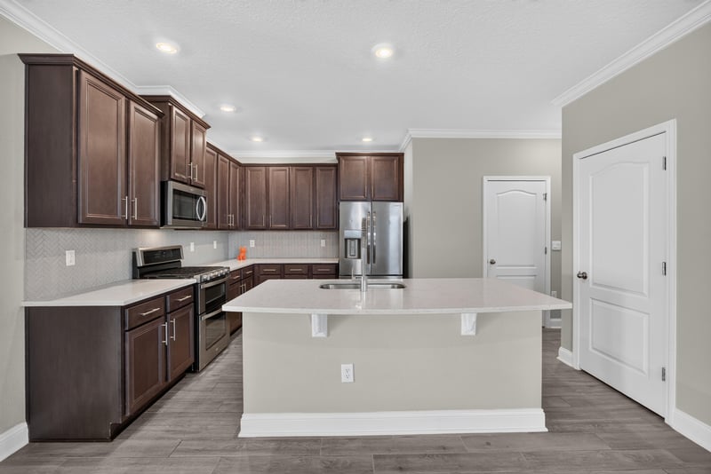 Kitchen island with bar seating space at 331 Millerstone Dr, St. Augustine, FL 32092