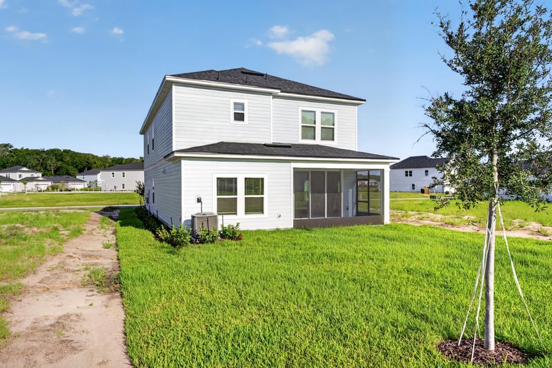 Rear exterior view with screened porch and lawn at 269 Bluegrass Wy, St. Augustine, FL 32092