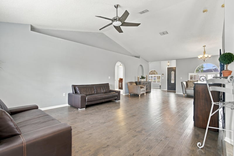 Great room with leather sofa and ceiling fan at 11197 Illford Dr