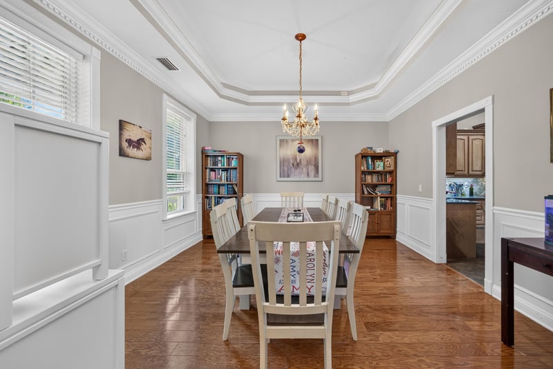 Dining room with white chairs and built-in shelving at 1735 Hagans Ridge Ct